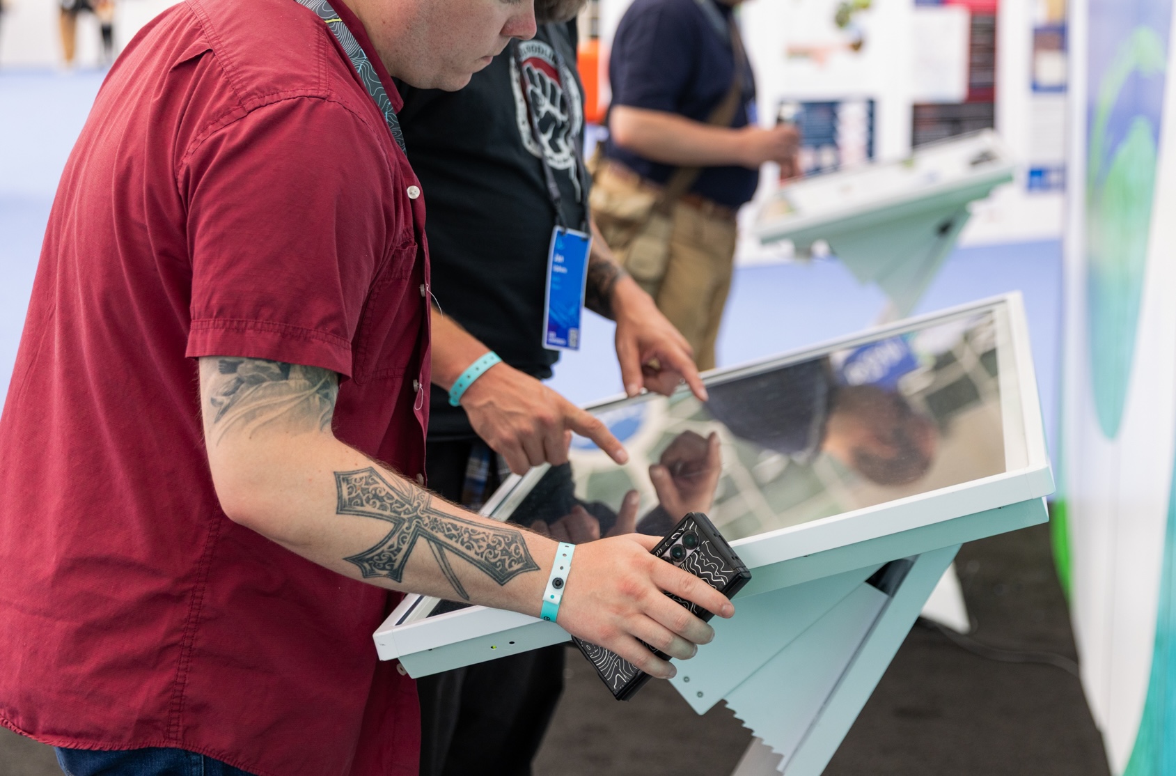 Attendees engaging directly with the touchscreen